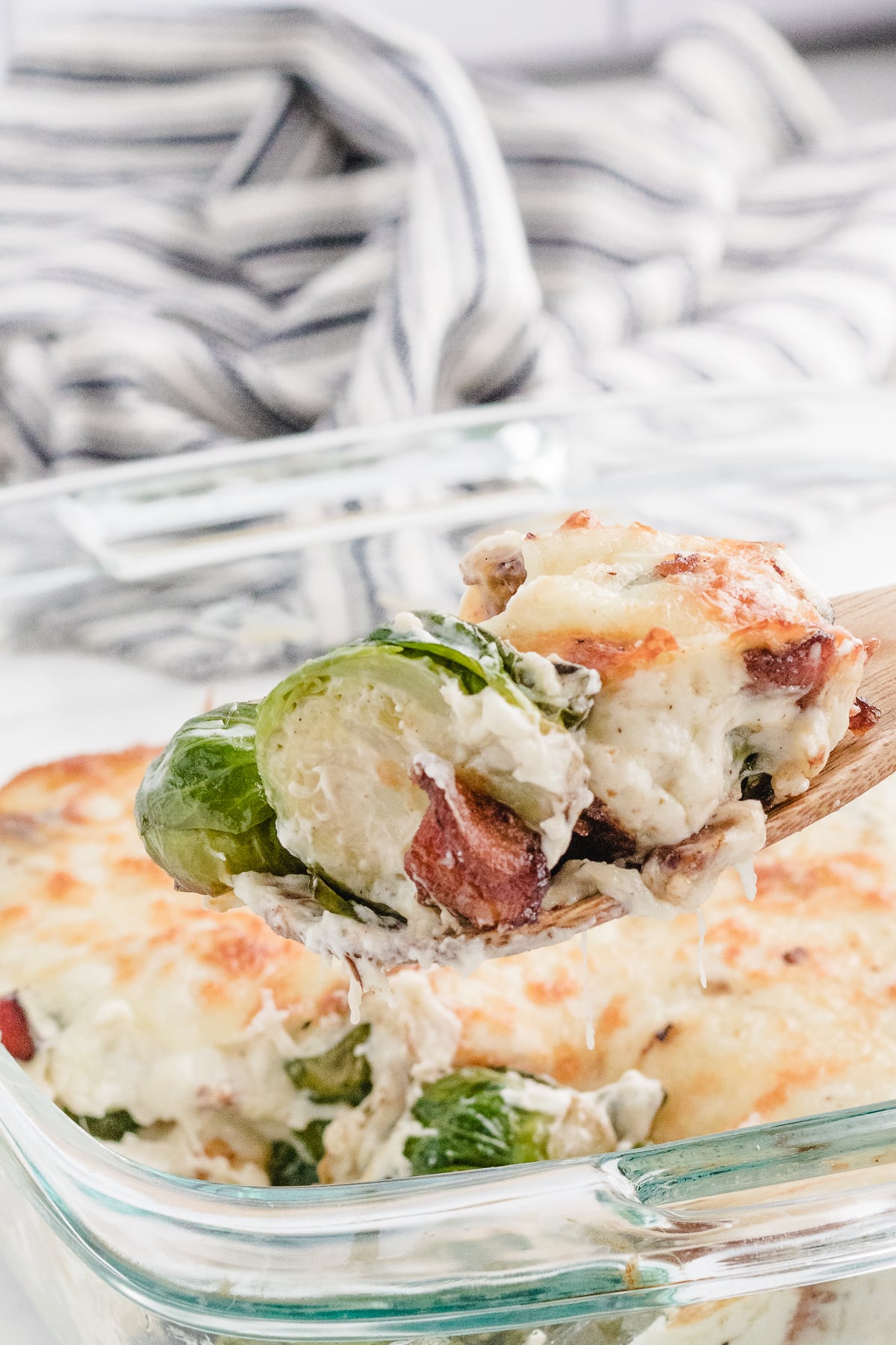 brussel sprouts with bacon casserole with a bite on a spoon