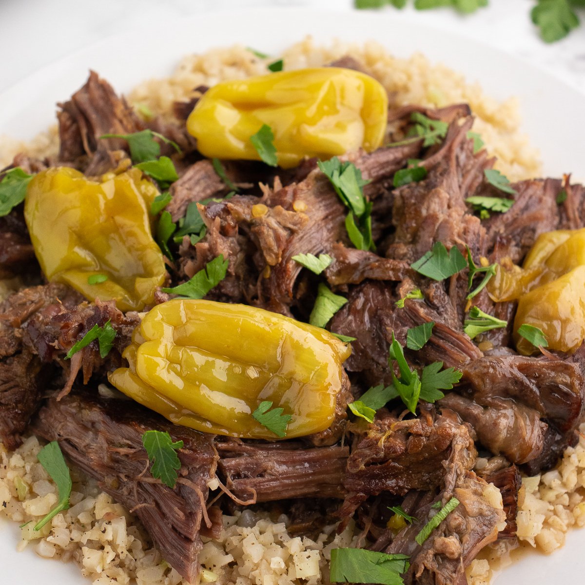close up of shredded beef on a place with rice