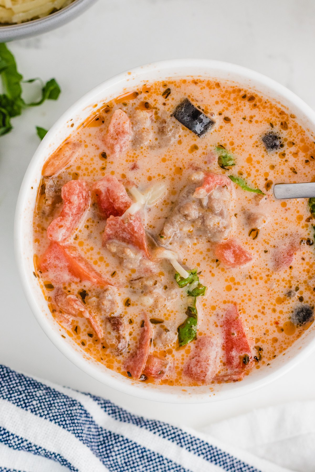 adding whipping cream to make a creamy pizza soup