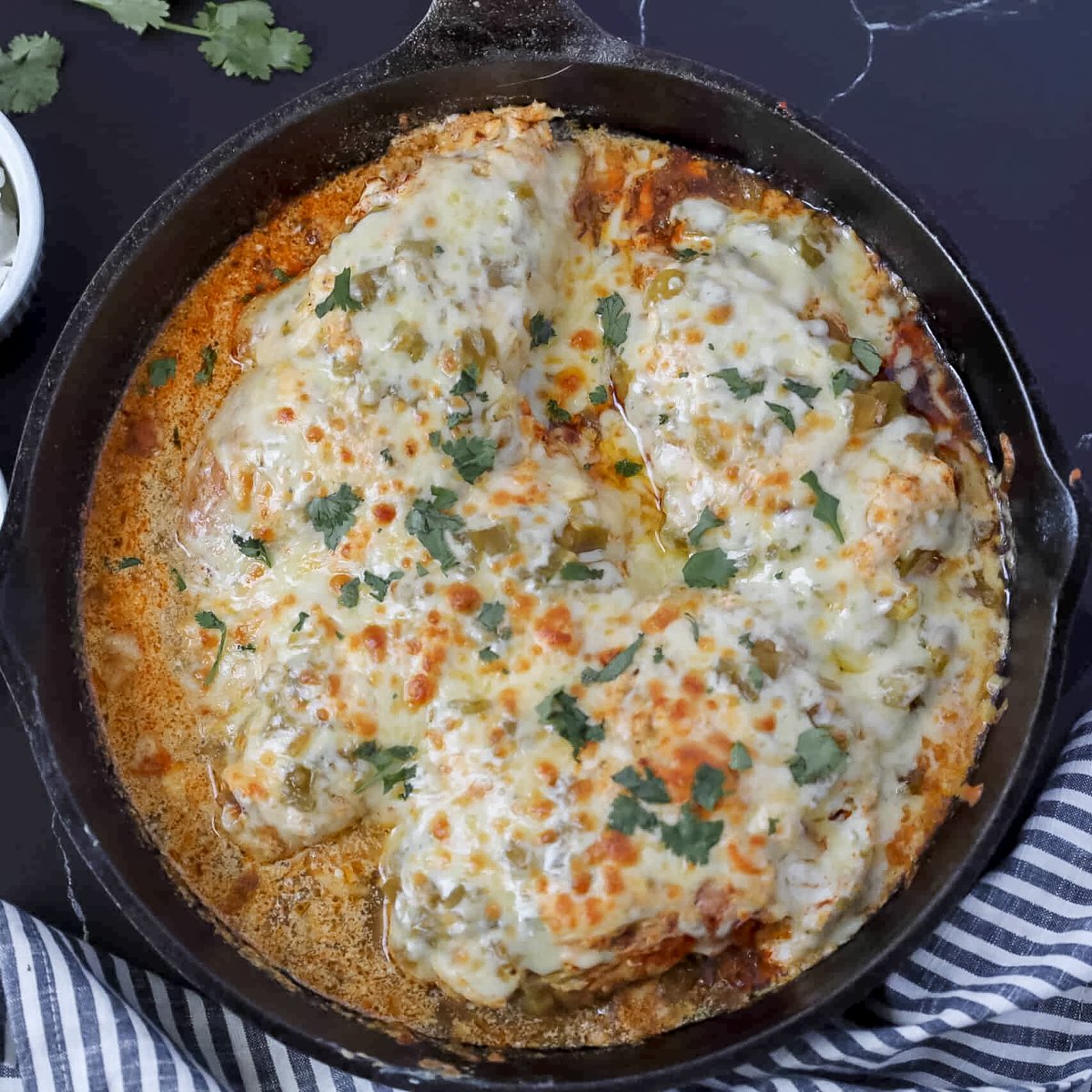 low carb green chili chicken bake in a cast iron skilet