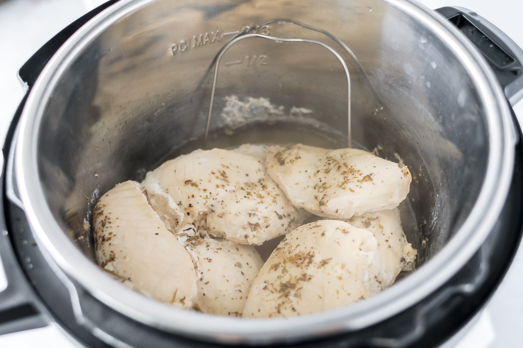pressure cooked boneless skinless chicken breast after cooking in the steamer basket