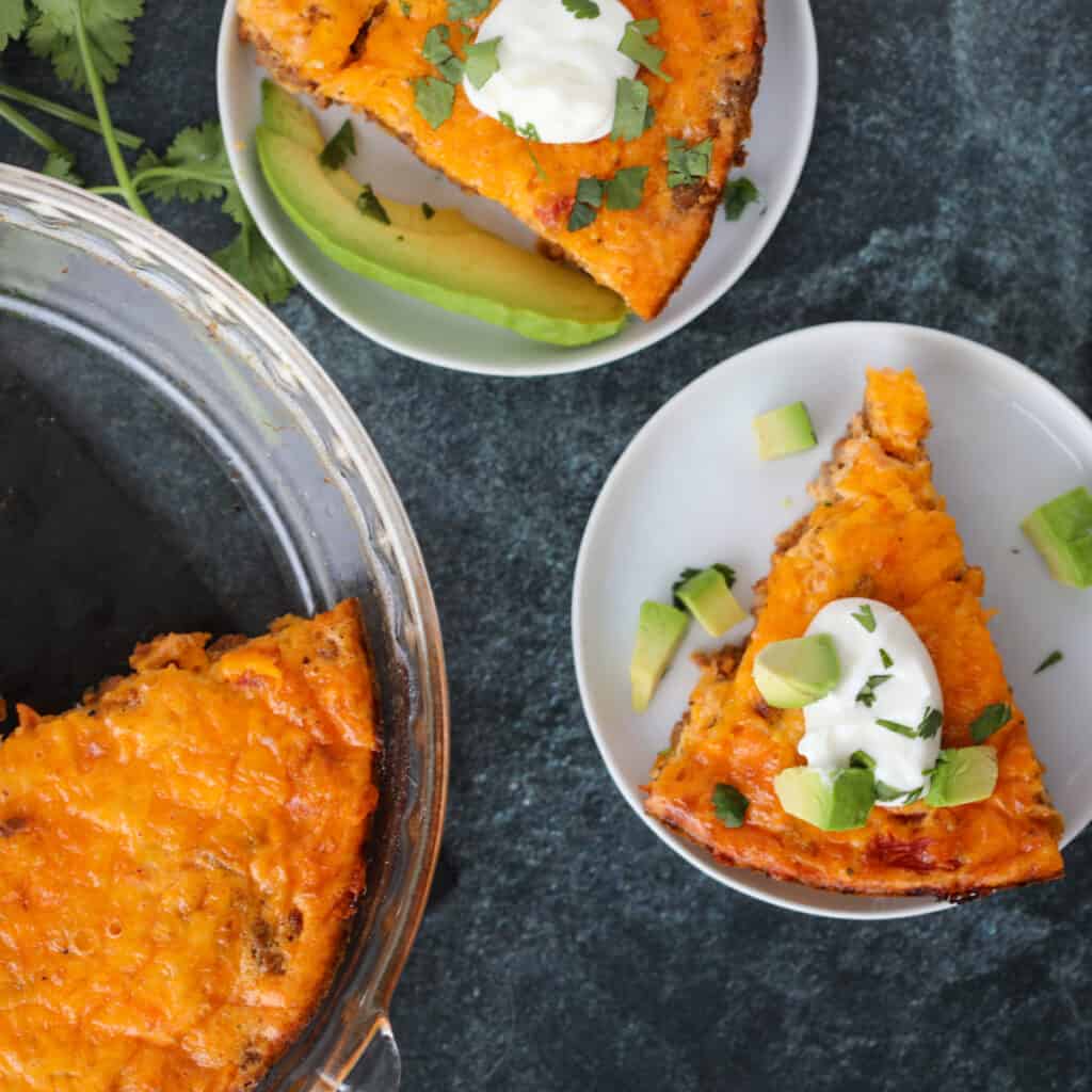 low carb taco pie in slices top down view on a black background