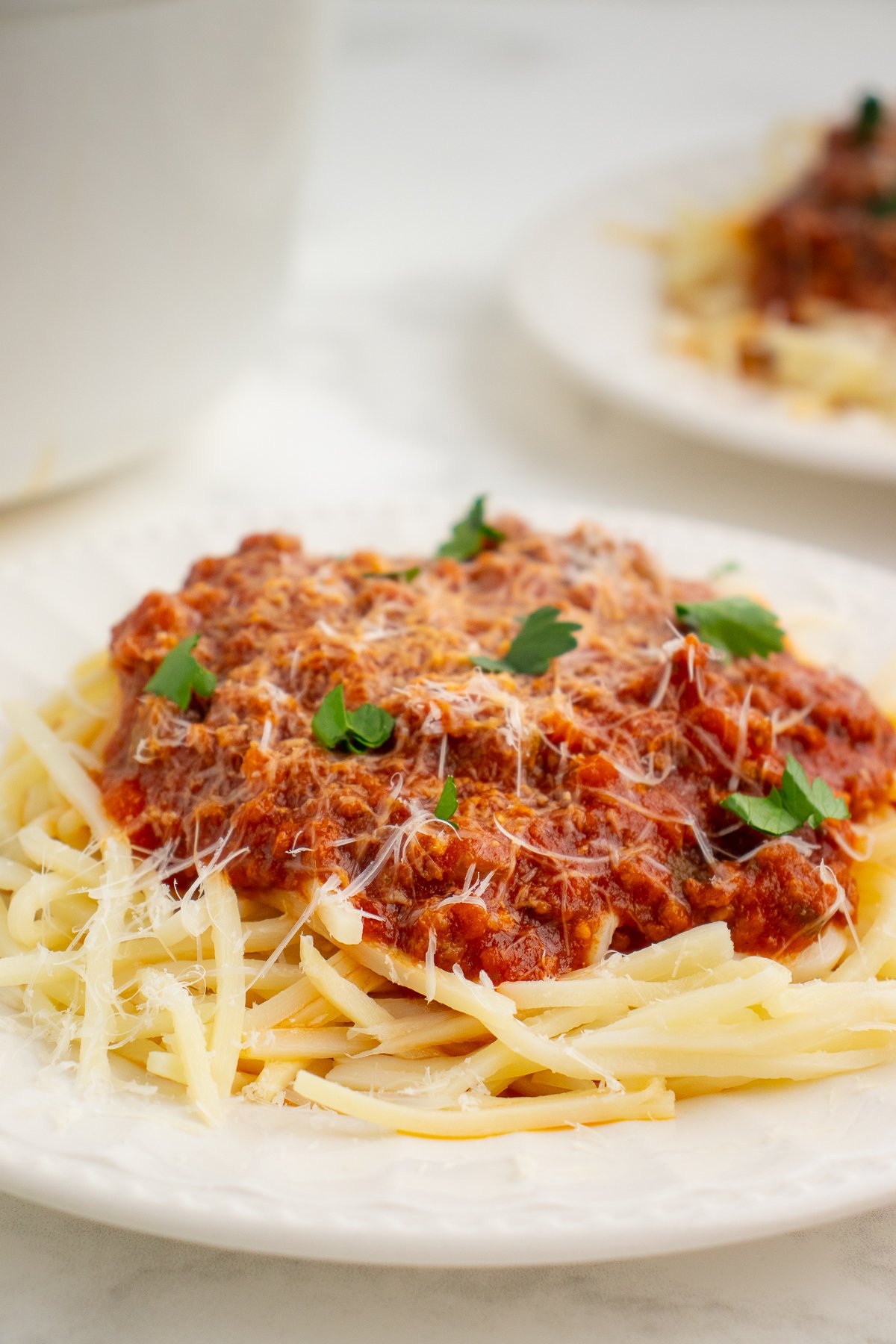 low carb meat sauce on a bed of low carb pasta topped with shredded parmesan cheese