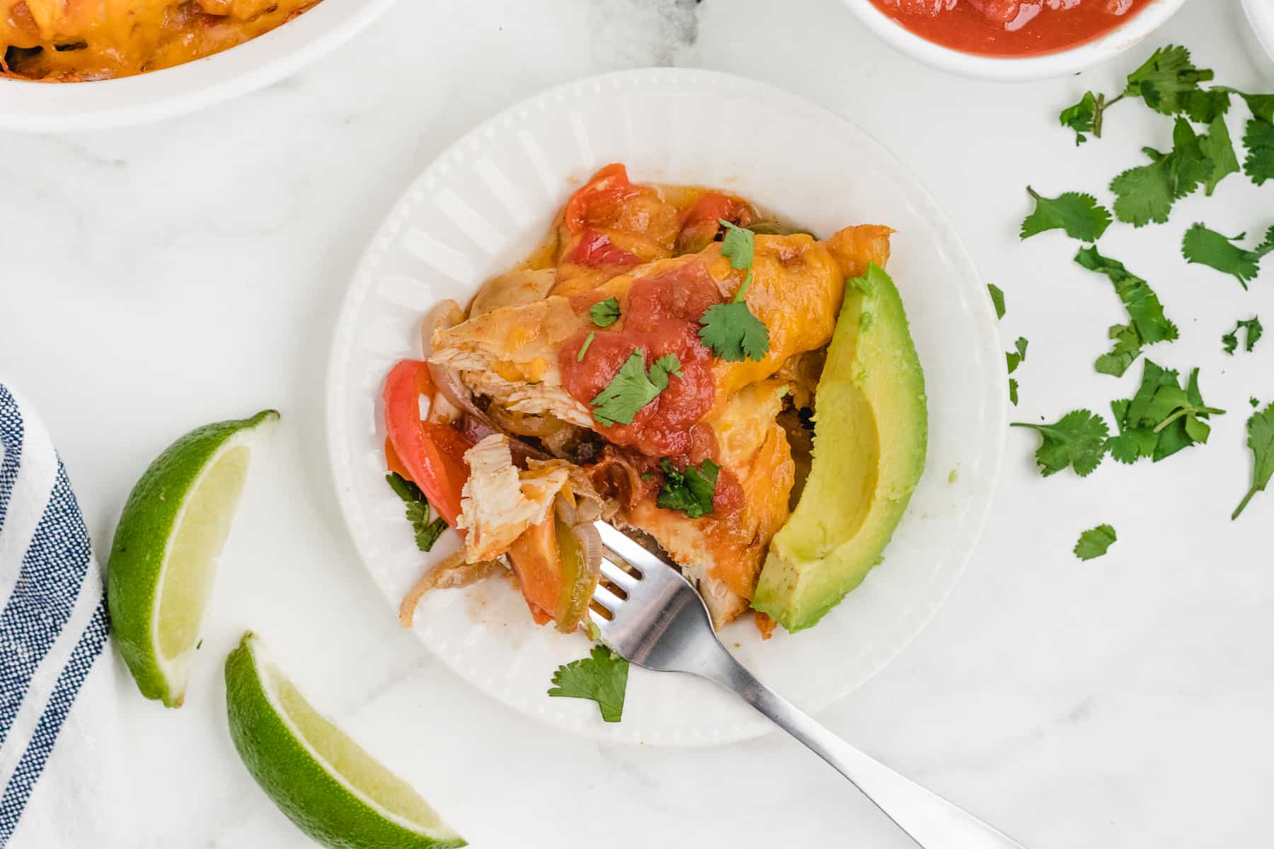 fajita bake on a white plate with garnishes