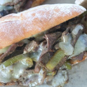 the best philly cheesesteak recipe closeup image with hot melted cheese