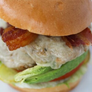 air fryer turkey burgers with lettuce, avocado, bacon, and swiss cheese