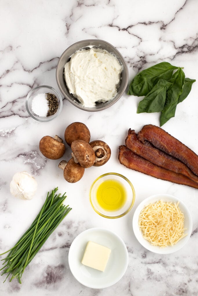 bacon cream cheese stuffed mushroom ingredients on a marble countertop