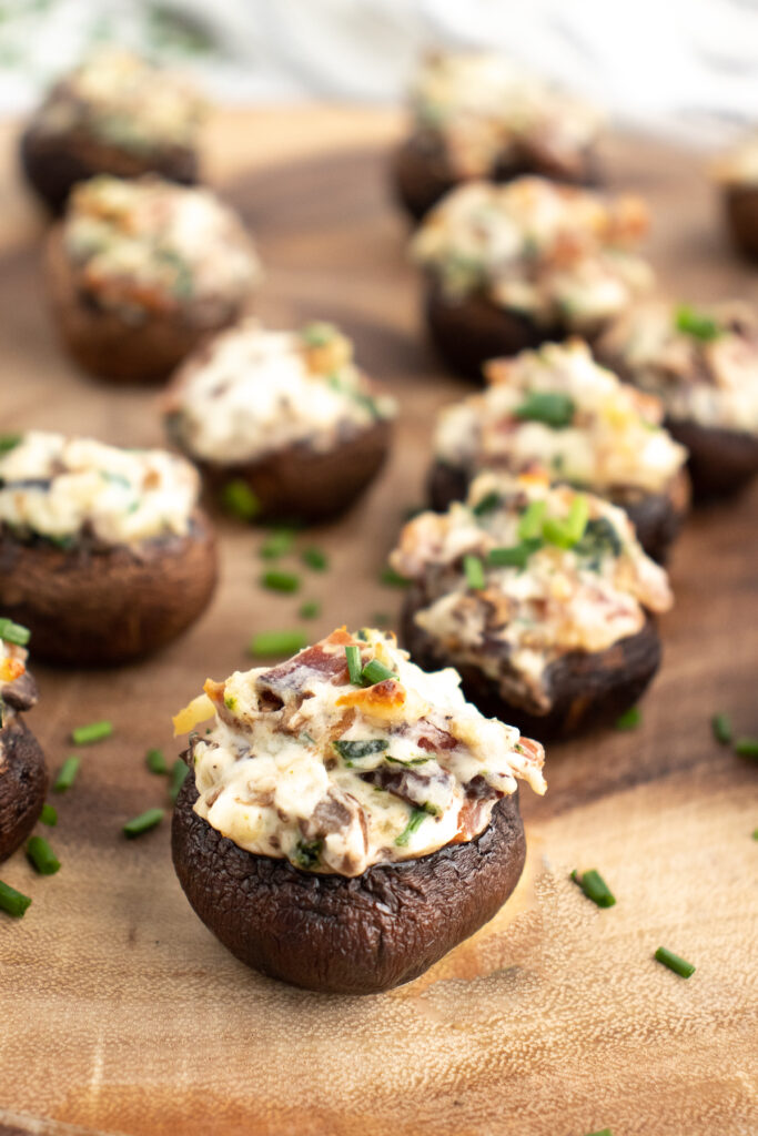 bacon stuffed mushrooms on a cutting board after baking