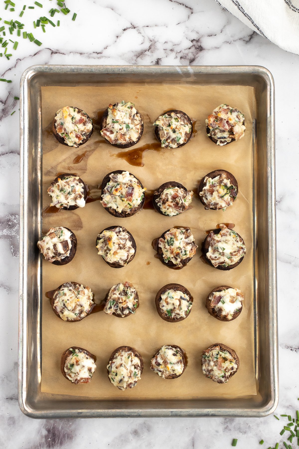 easy baked stuffed mushrooms with cream cheese and bacon bits cooling on the pan after baking