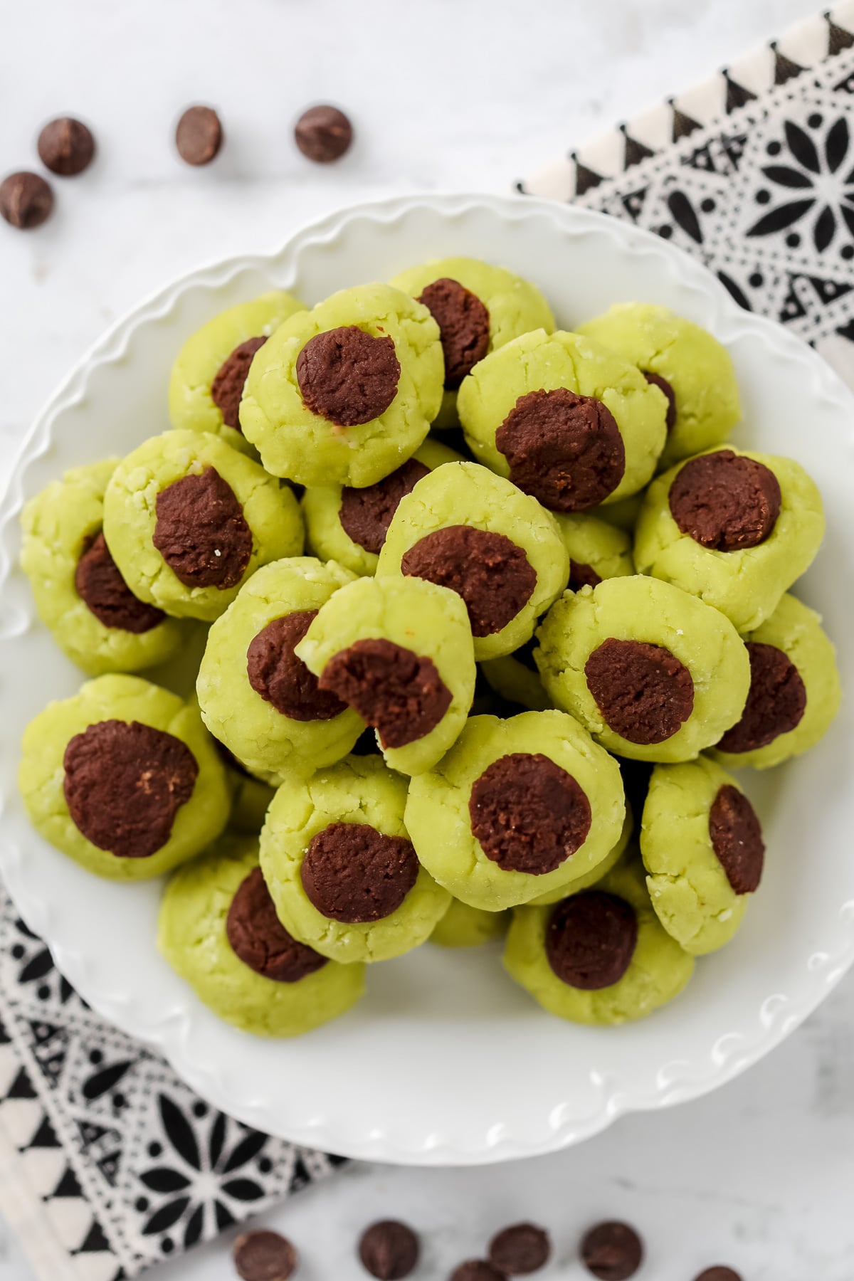 a top down view of a plate of low carb sugar free mints on a white plate