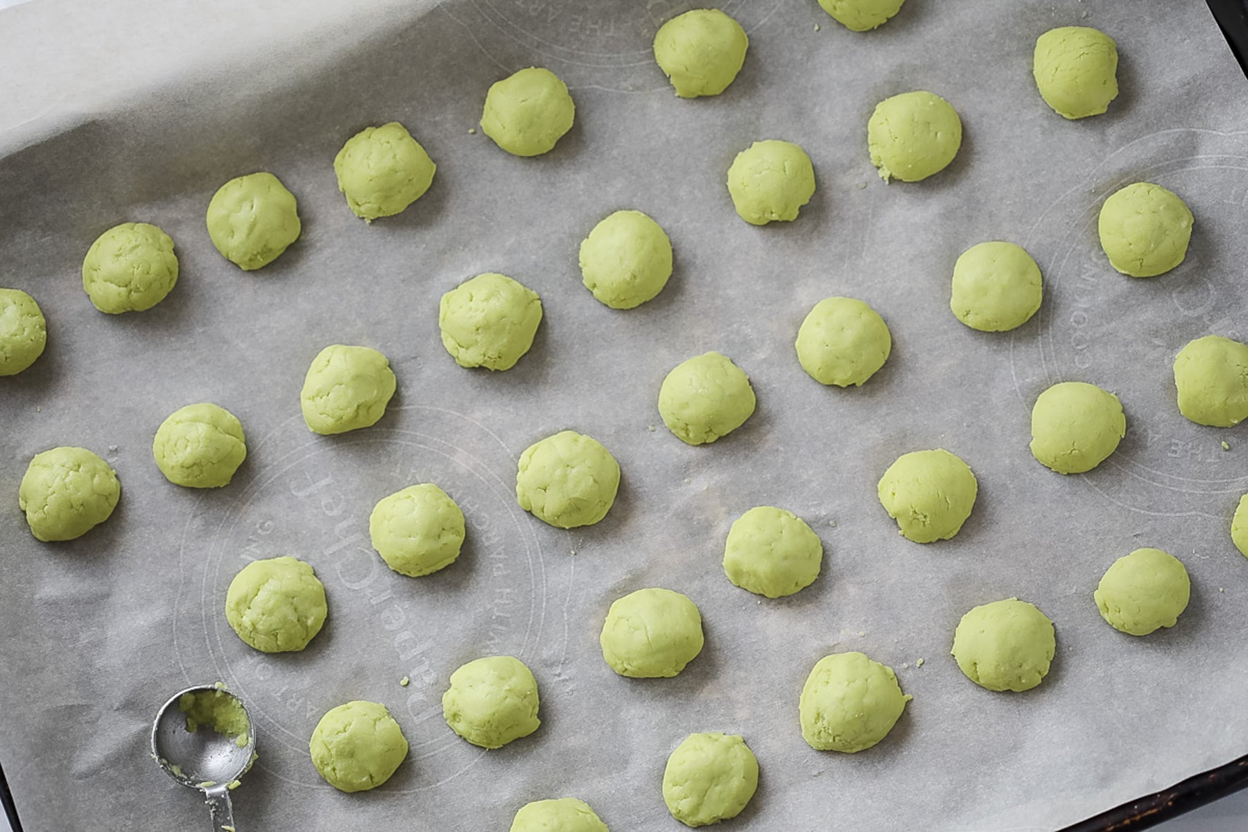 adding sugar free mint balls to a baking sheet