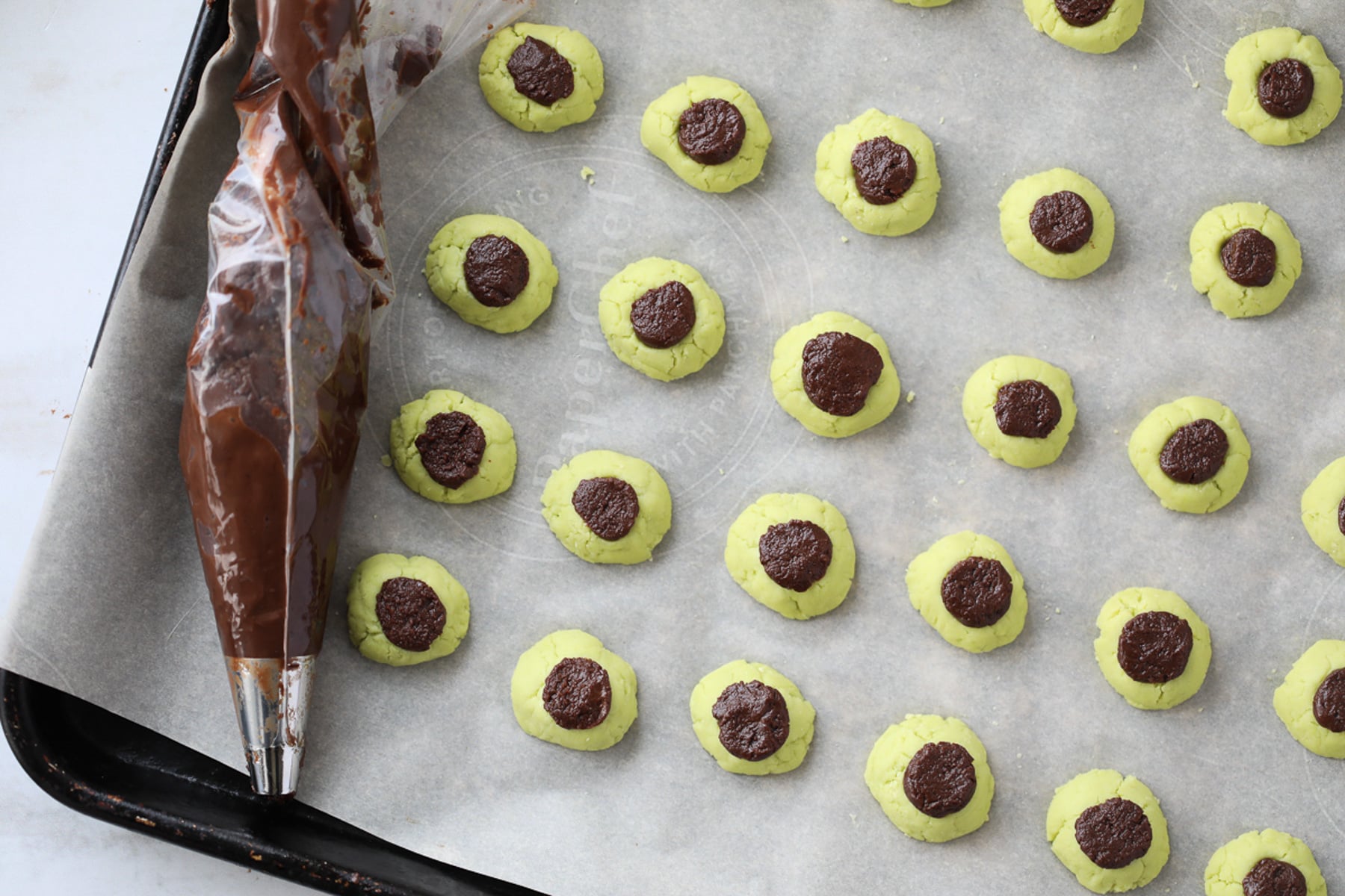 fill the sugar free mint candies with the chocolate using a piping bag