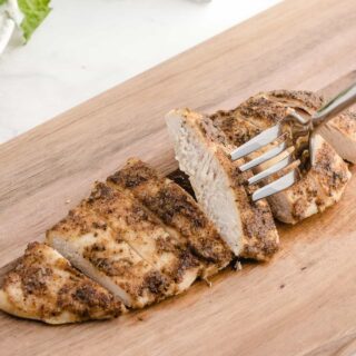 baked thin sliced chicken breast on a cutting board