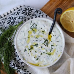 low fat tzatziki sauce using fat free Greek yogurt in a bowl drizzled with olive oil