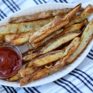 crispy steak fries in air fryer with seasoning and ketchup