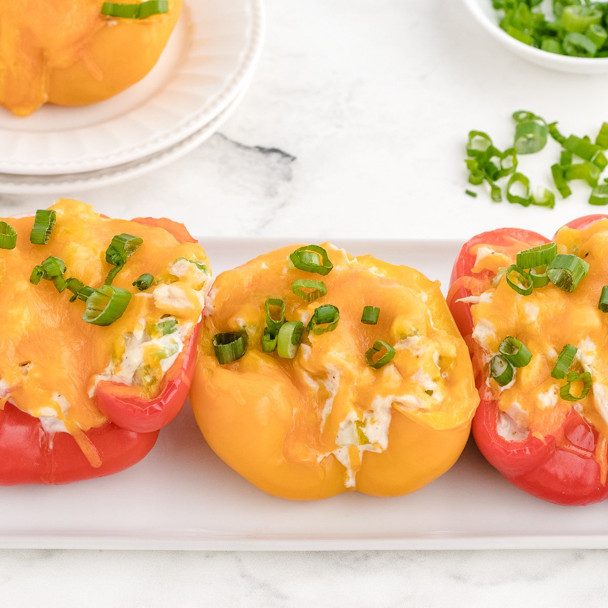 tuna melt stuffed peppers recipe lined up on a tray ready to serve