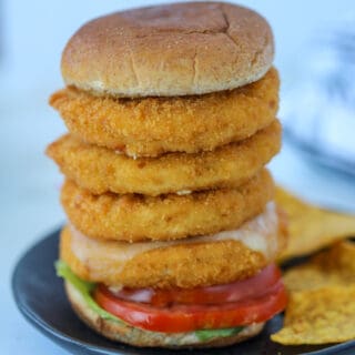 chicken patties in air fryer stacked on a bun