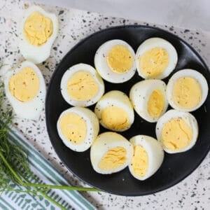 hard boiled eggs in air fryer cut in half served with salt and pepper