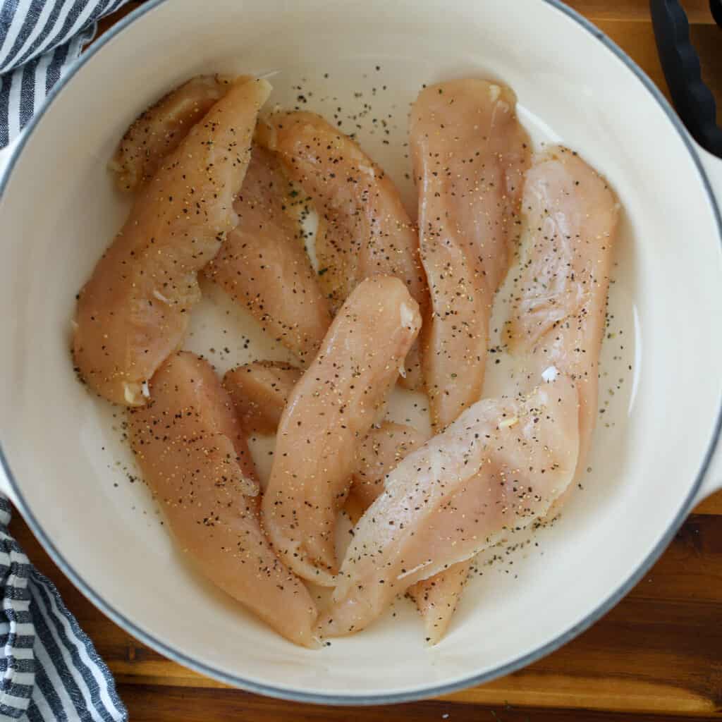 stovetop chicken tenders in the bottom of a pot before adding water