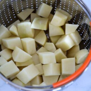 instant pot diced potatoes raw in a collander