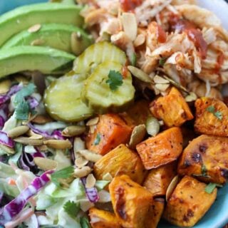bbq chicken bowls with sweet potatoes and garnishes like bbq sauce and cilantro