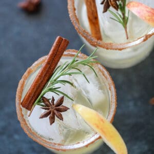 spicy cider margarita close up with rosemary and cinnamon