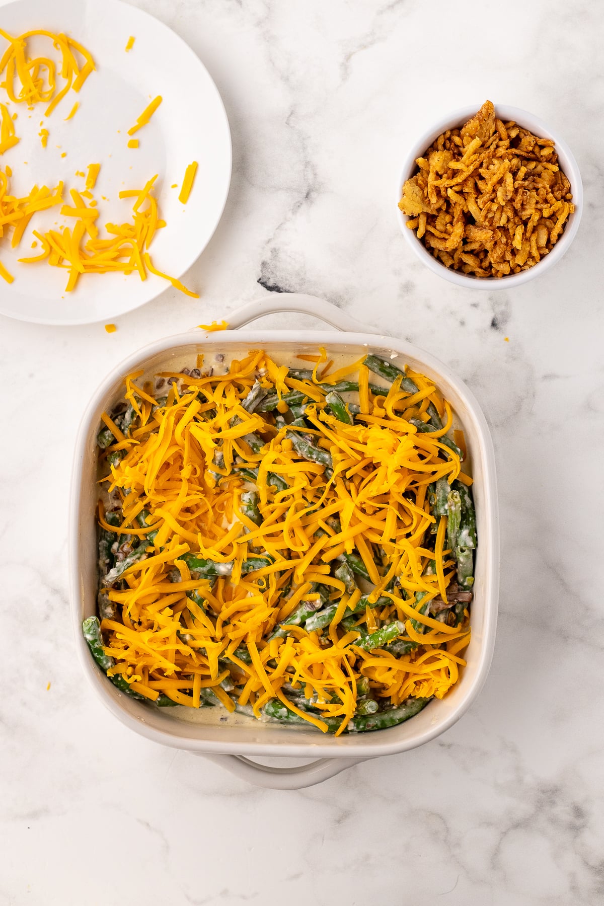 sprinkle the top of the green bean casserole with shredded cheese