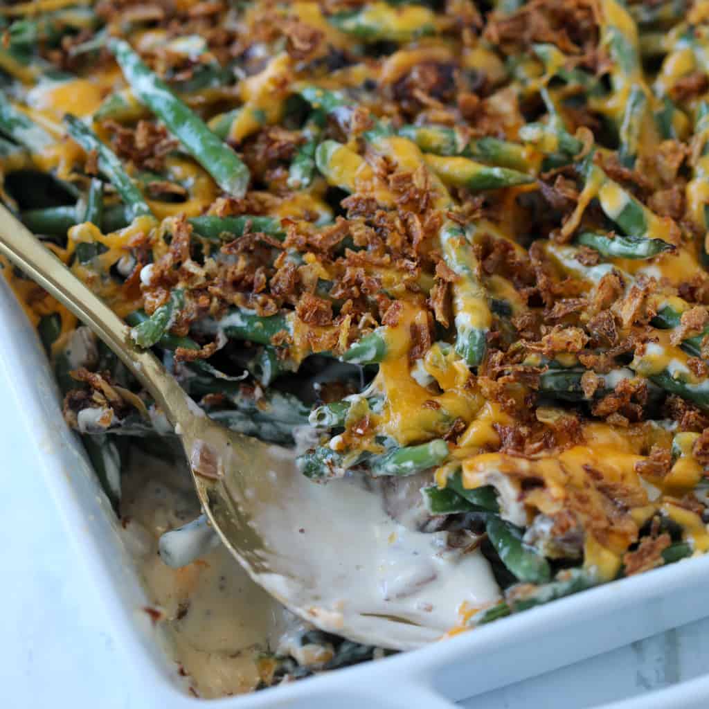 fresh green bean casserole without mushroom soup after baking with a bite out of the casserole