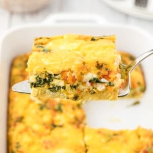 A slice of breakfast casserole on a spatula.
