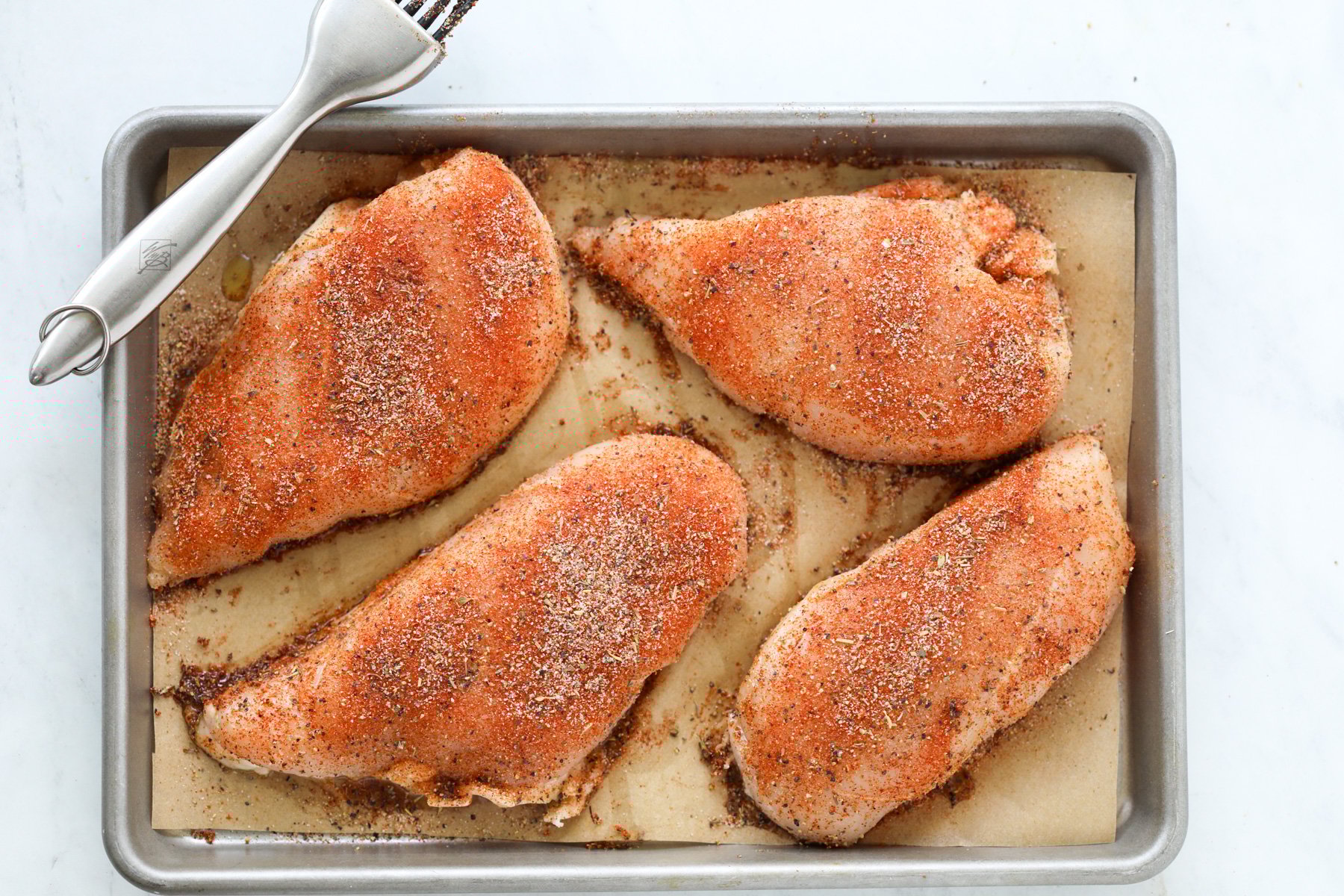 sprinkle the chicken rub on the chicken breast pieces before baking