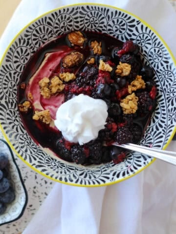 protein yogurt bowl close up image with granola sprinkled on the top