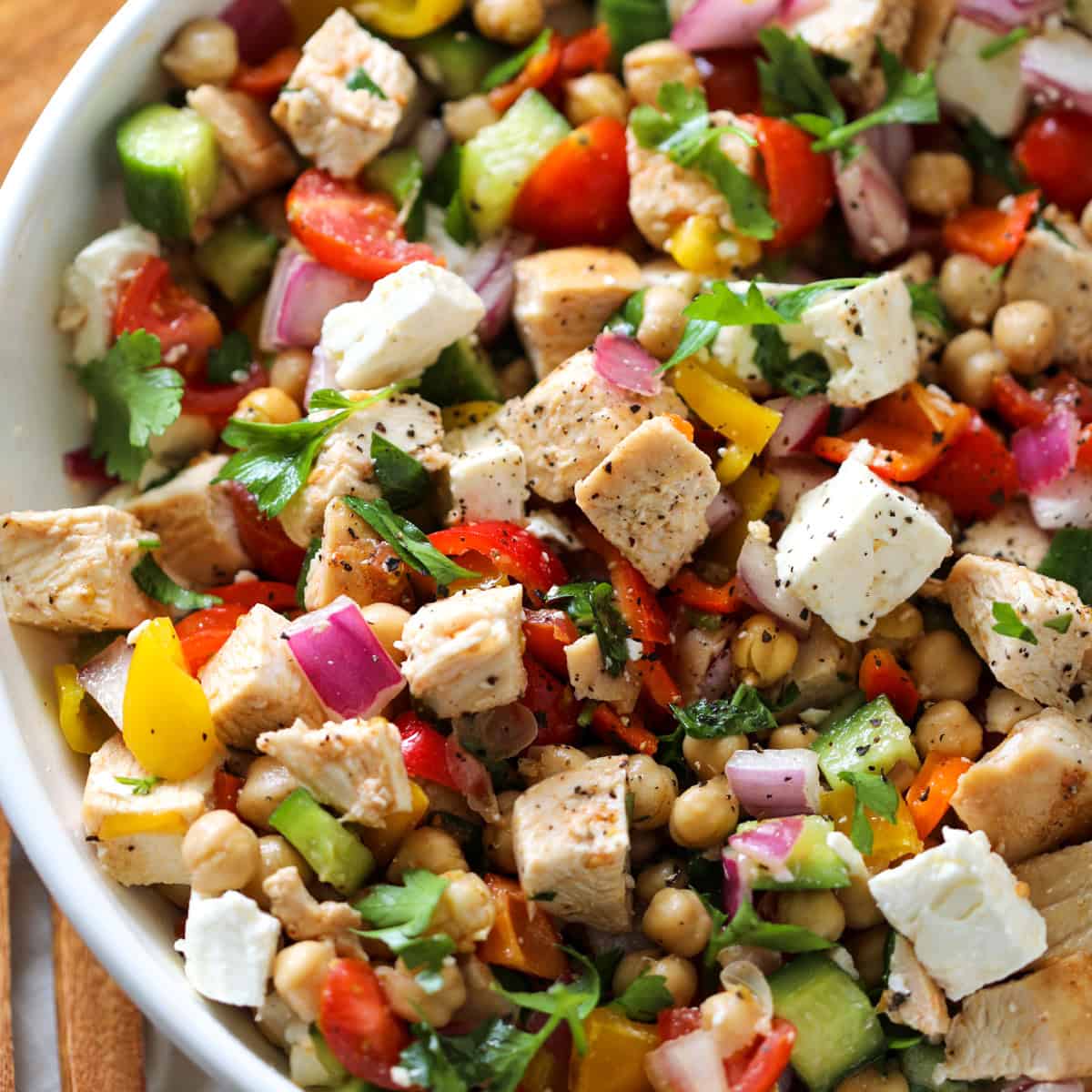 close up of the chicken salad with feta and chickpeas in a white bowl before serving