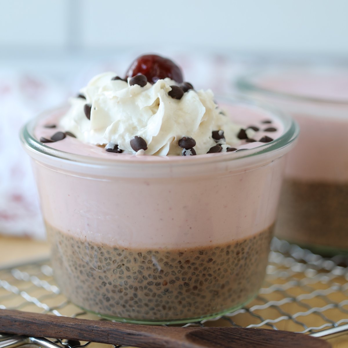 chocolate chia pudding with greek yogurt and almond milk topped with whipped cream and chocolate chips