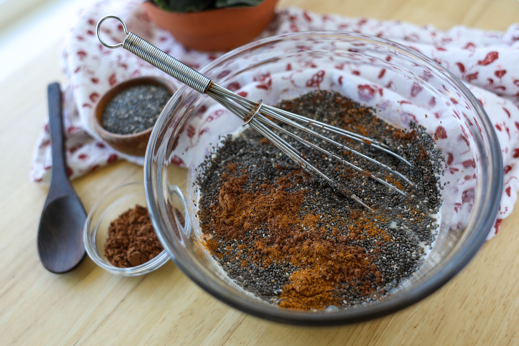 how to make chocolate chia seed pudding in a bowl surrounded by the ingredients