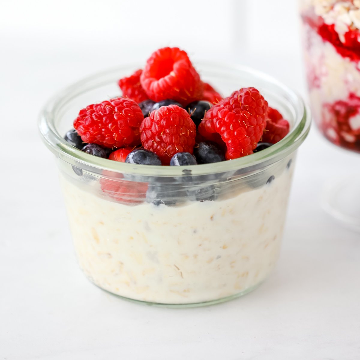 oats and cottage cheese in a jar topped with berries