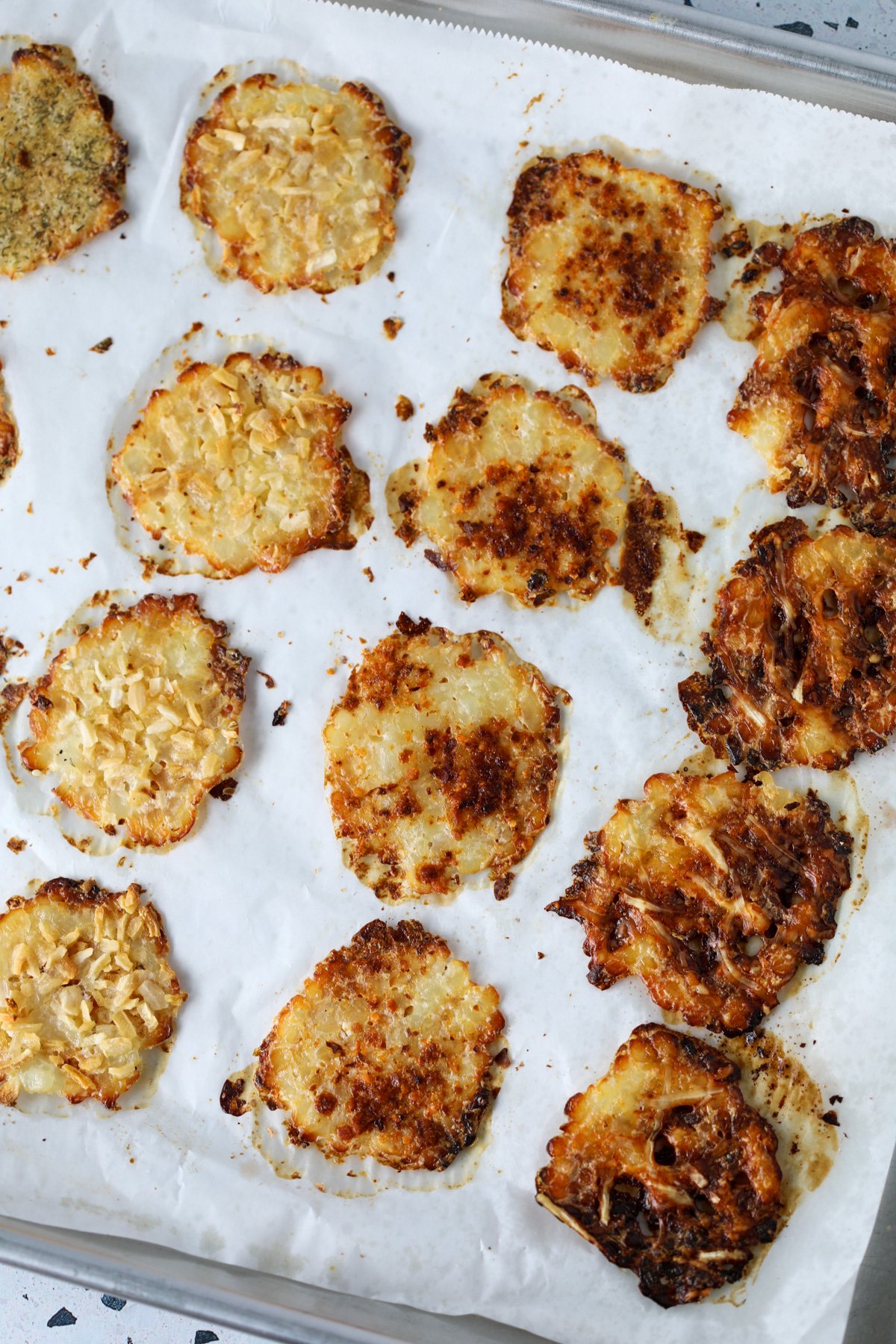 oven baked cottage cheese chips coming out of the oven and cooling on a cutting board