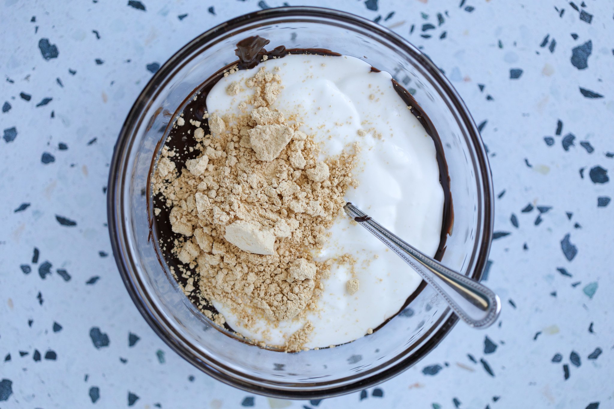 combining the blended cottage cheese, melted chocolate chips, and peanut butter powder in a bowl.