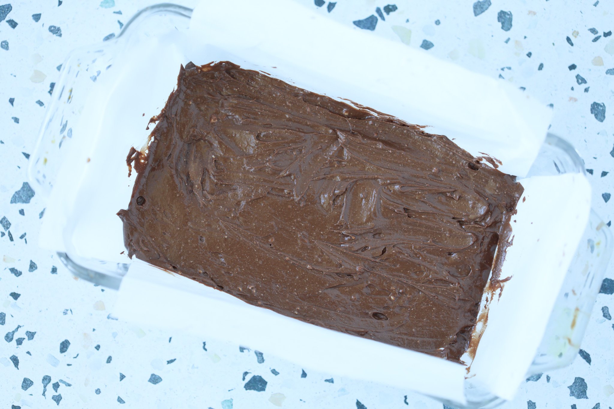 pour the cottage cheese fudge into a loaf pan lined with parchment paper