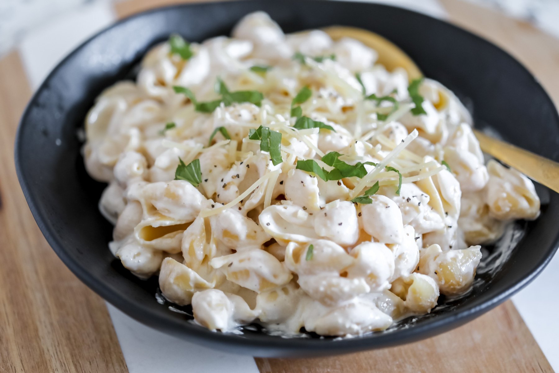 close up angle view of the high protein cottage cheese alfredo garnished with parmesan and ready to serve