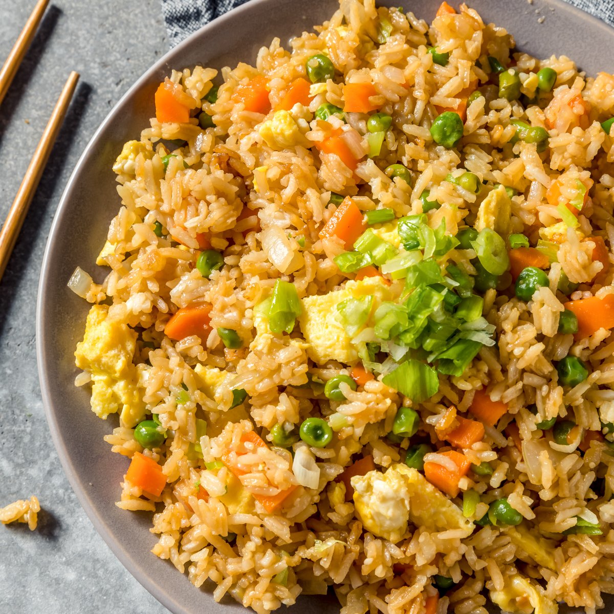 the best blackstone chicken fried rice with vegetables in a gray serving bowl close up image