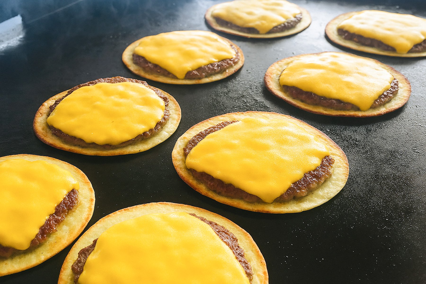 blackstone big mac smash burger tacos on a flat top griddle melting the American cheese