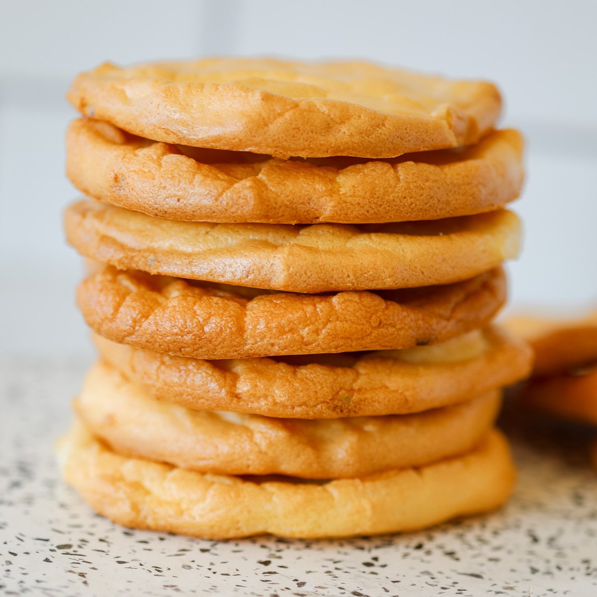 a close up image of the easy cottage cheese cloud bread stacked up