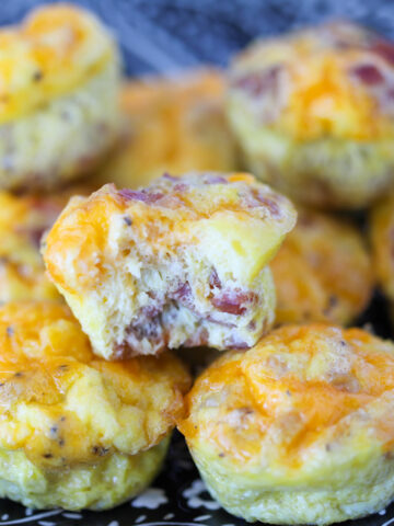carnivore egg muffins on a plate ready to eat with a bite taken out of one muffin