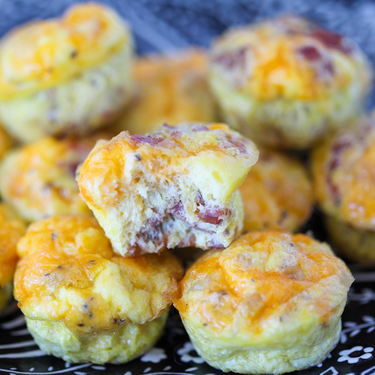 carnivore egg muffins on a plate ready to eat with a bite taken out of one muffin