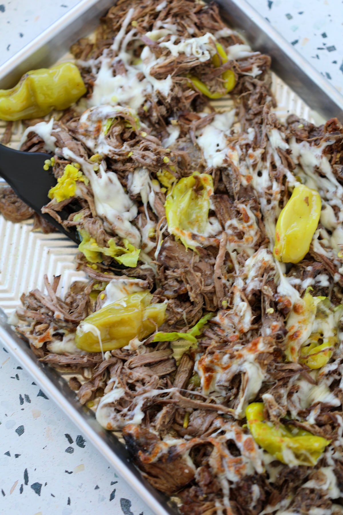 no carb crockpot italian beef topped with mozzarella cheese and pepperoncini peppers