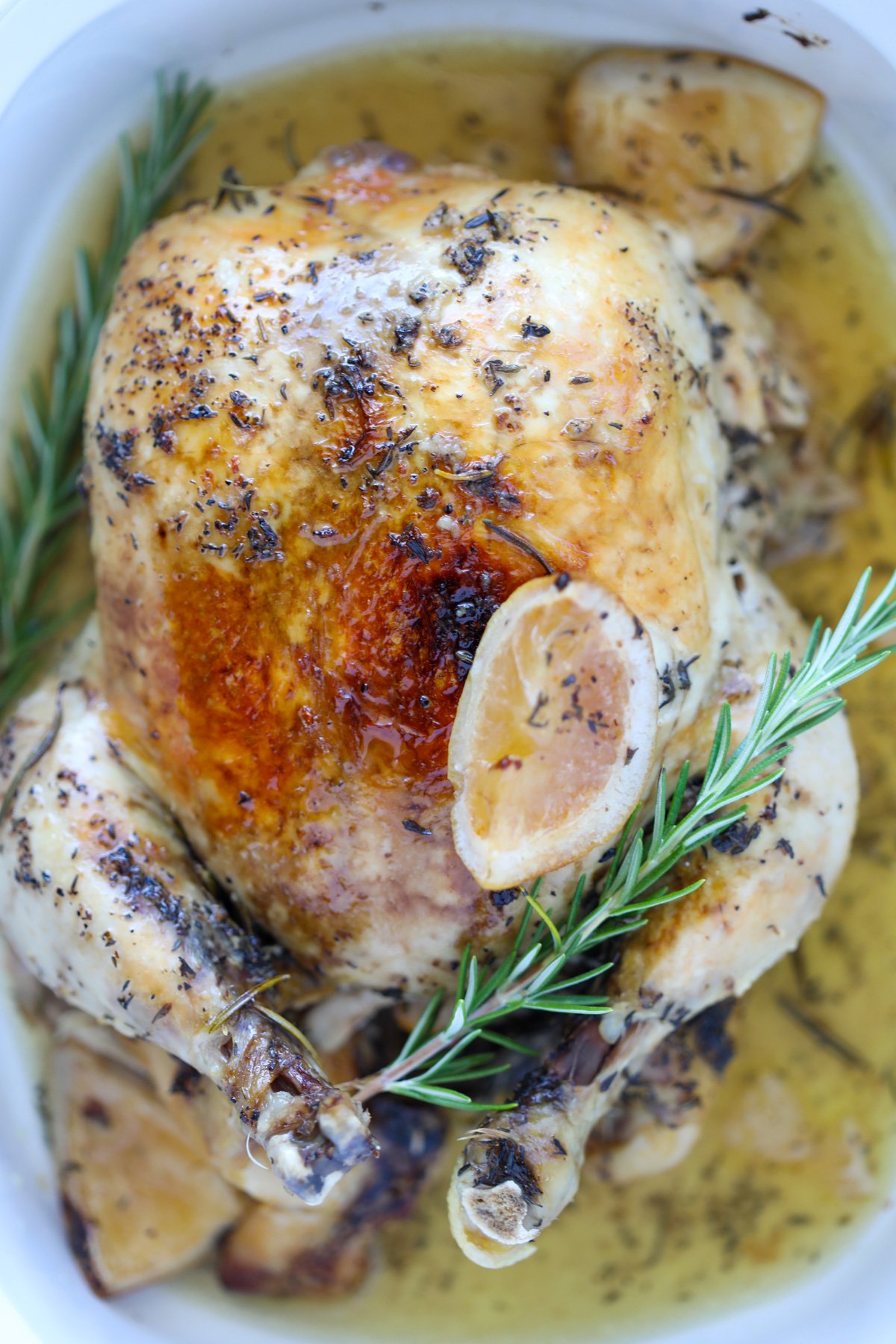 no carb crockpot roast chicken in a slow cooker with lemons and rosemary