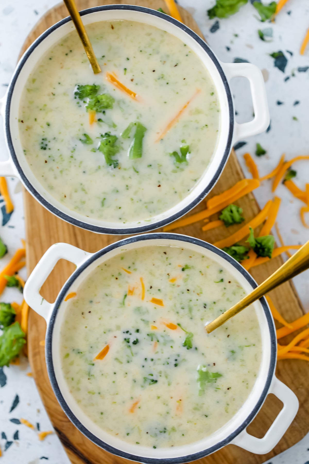high protein vegetable soup with broccoli and cheddar cheese in a white bowl