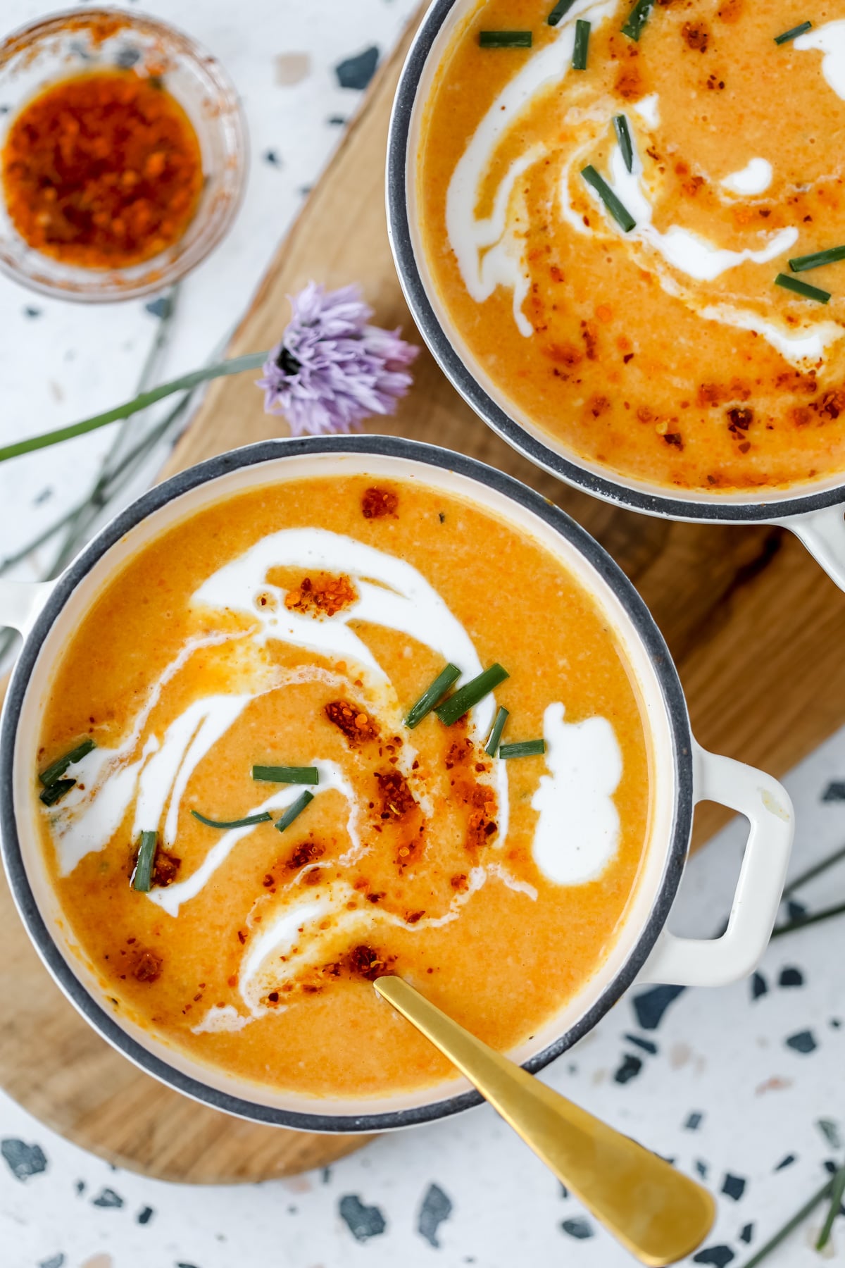 high protein vegetable soup with carrots ginger and cottage cheese in a white bowl