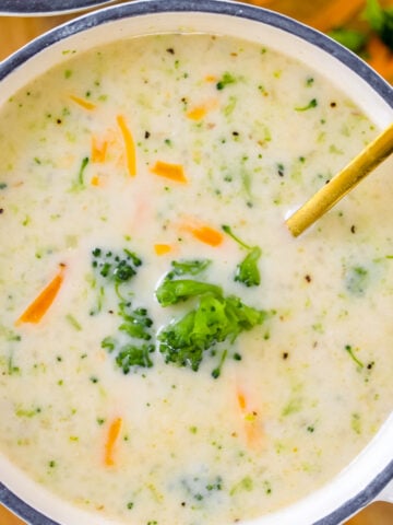 creamy bowl of high protein broccoli cheddar soup with spoon