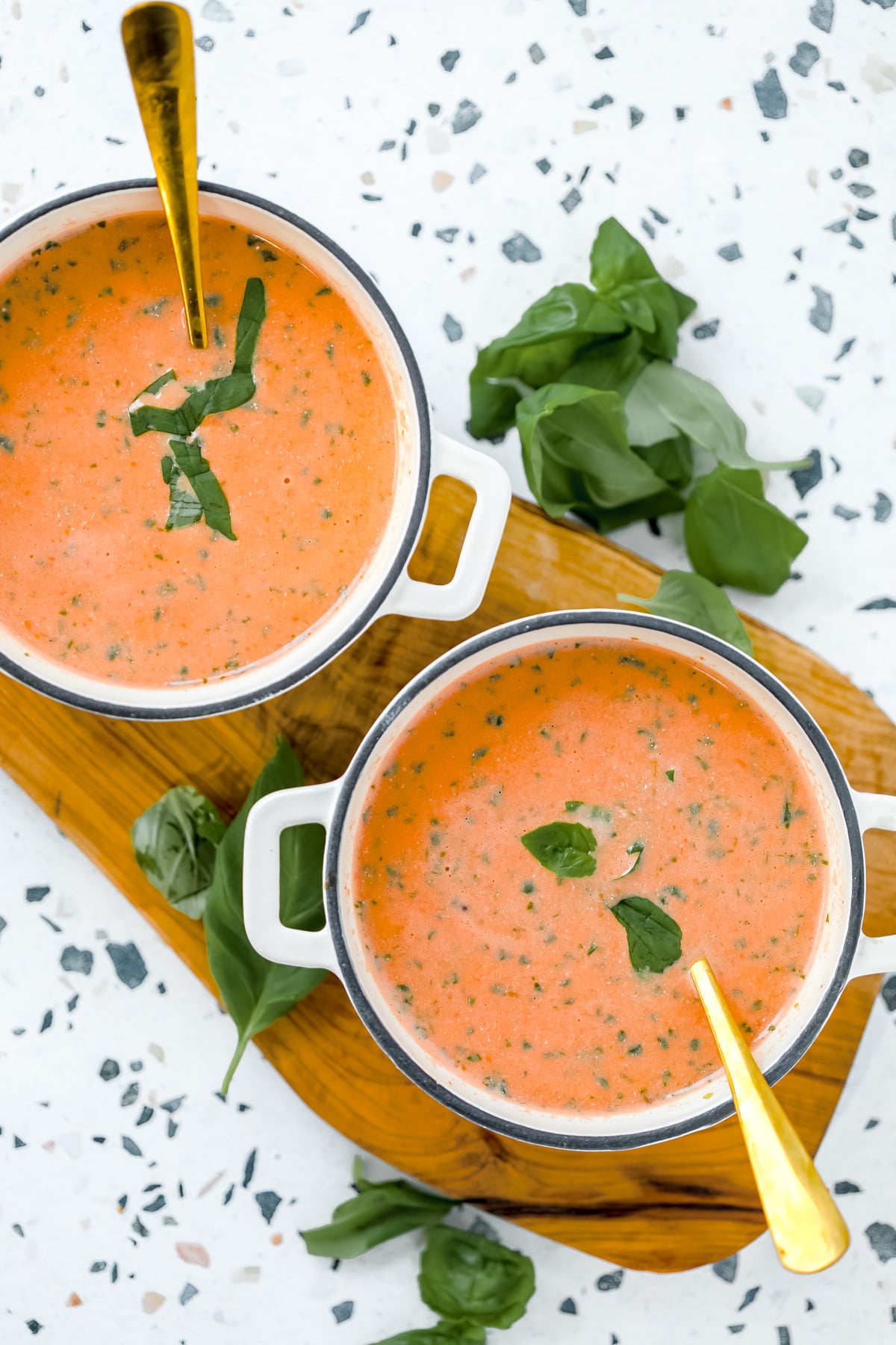 creamy high protein tomato soup being served in bowls